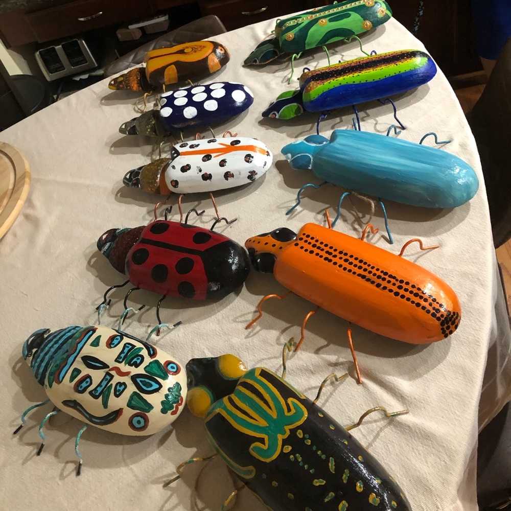 Hand painted wooden garden beetles.